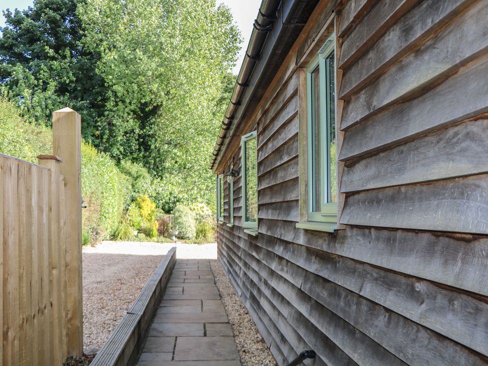 A pathway beside a wooden fence and garden at El -Nido Alton