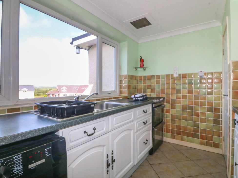 A kitchen with a sink and oven at Llain Delyn Capel Mawr near Malltraeth