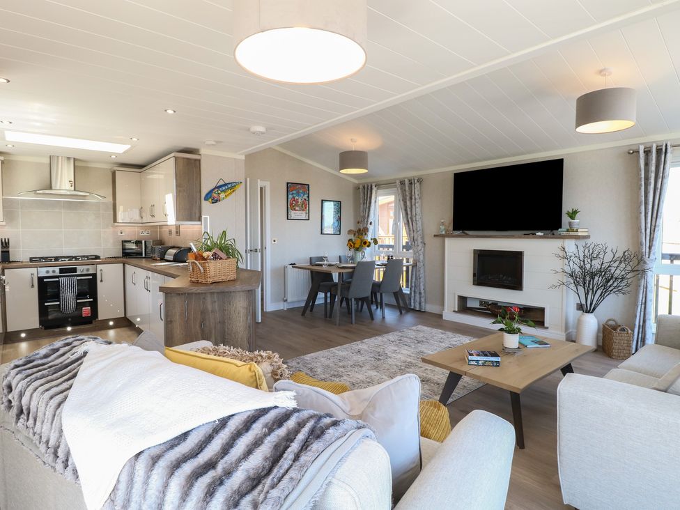 A living room with a kitchen and dining area at Life's a Beach in Bacton