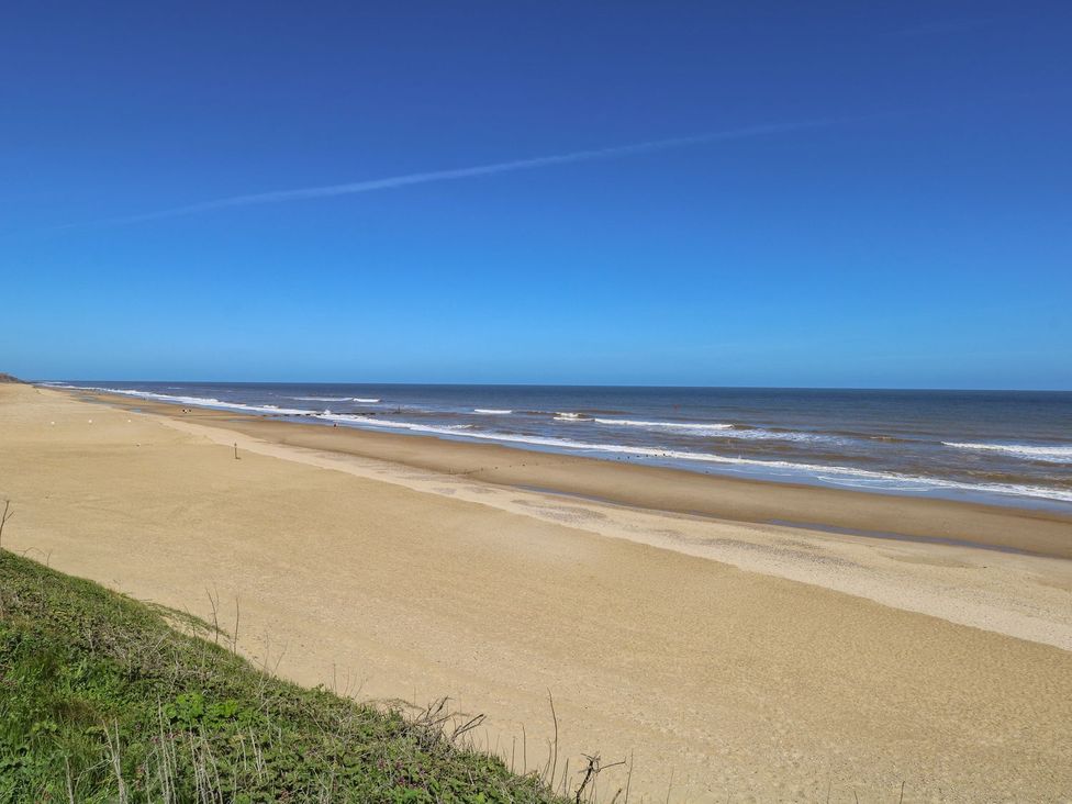 A beach with sand and ocean waves at Life's a Beach in Bacton