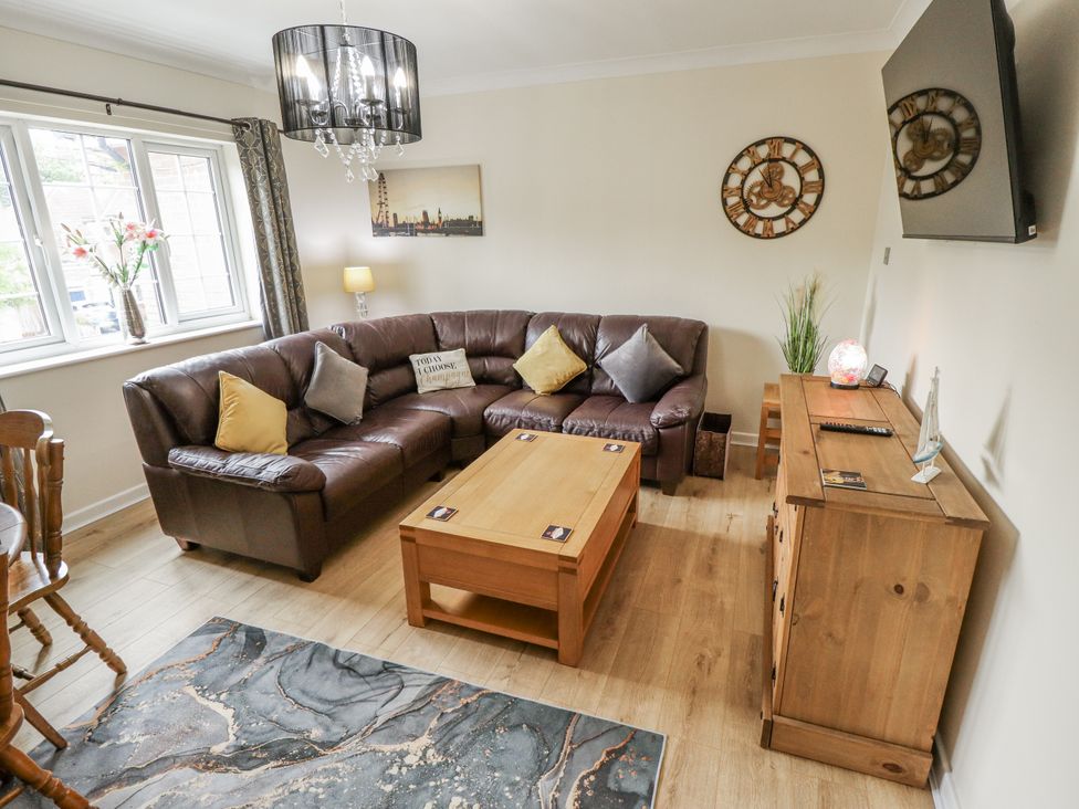 A living room with a sofa and coffee table at 5 Links Court in Skegness