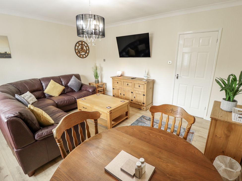 A living room with a sofa and coffee table at 5 Links Court in Skegness