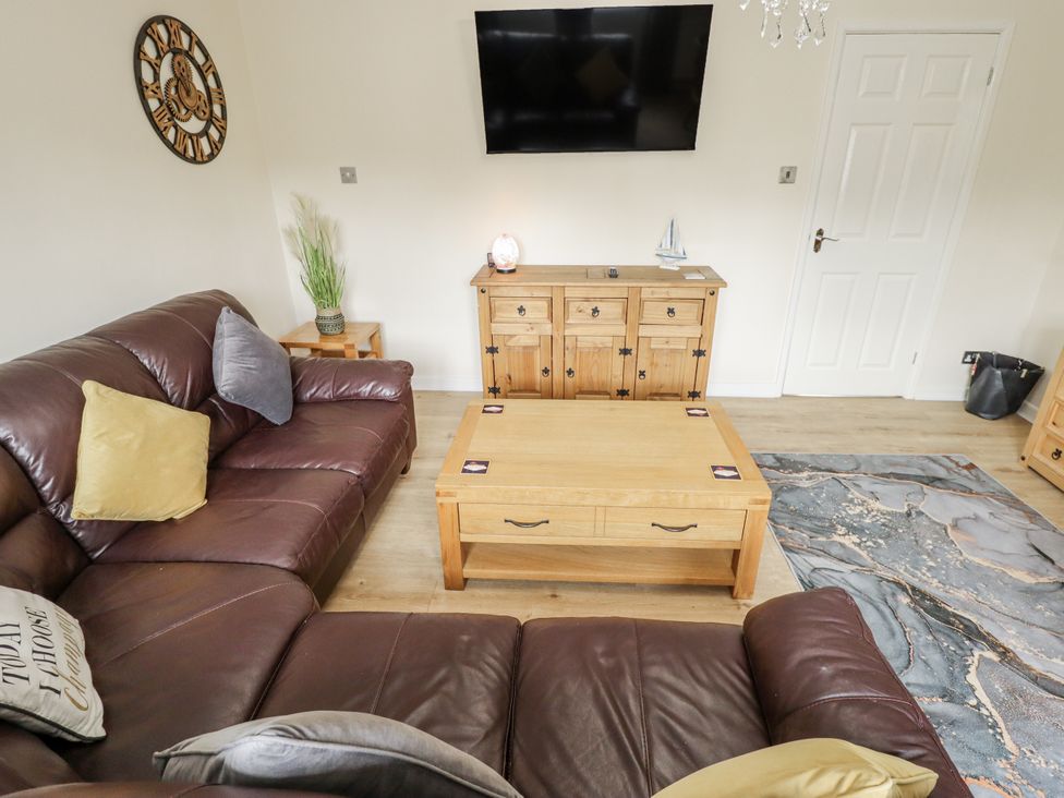 A living room with a sofa and coffee table at 5 Links Court in Skegness