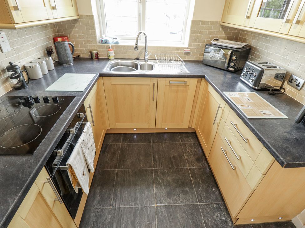 A kitchen with a sink and appliances at 5 Links Court in Skegness