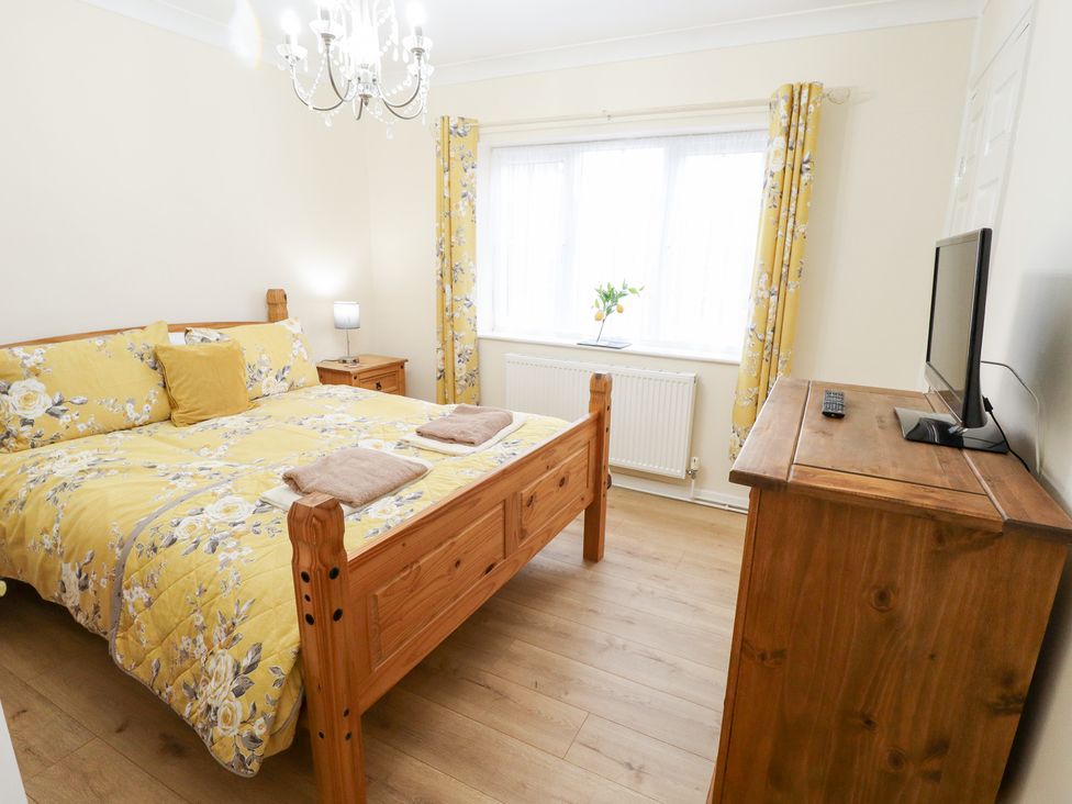 A bedroom with a bed and television at 5 Links Court in Skegness