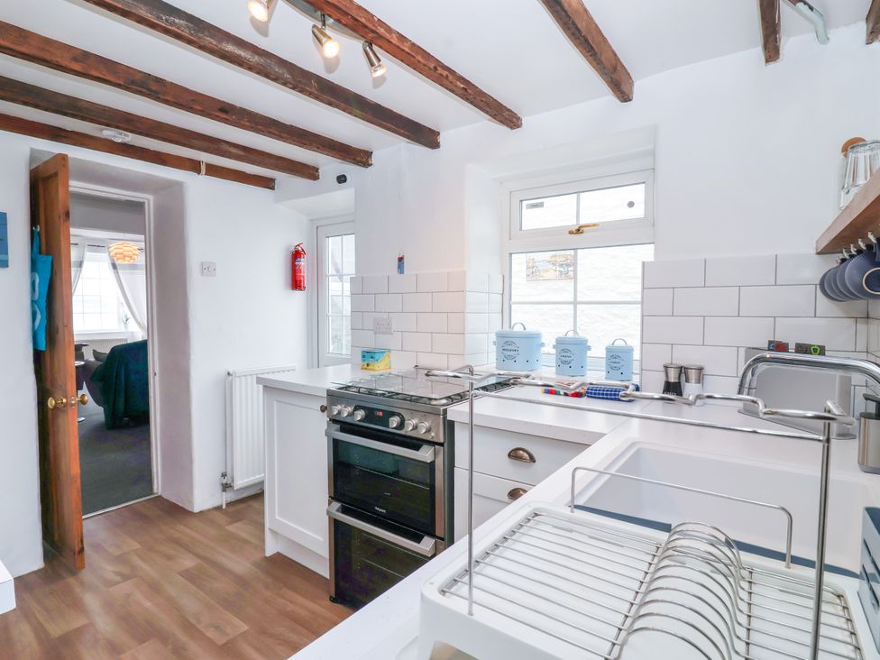 A kitchen with a stove and sink at 45 North View in Brixham
