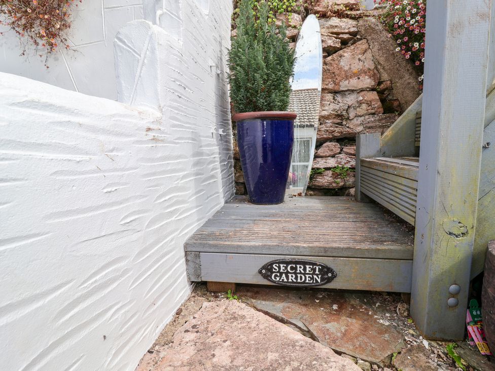 A garden entrance with a sign reading 'Secret Garden' at 45 North View Brixham