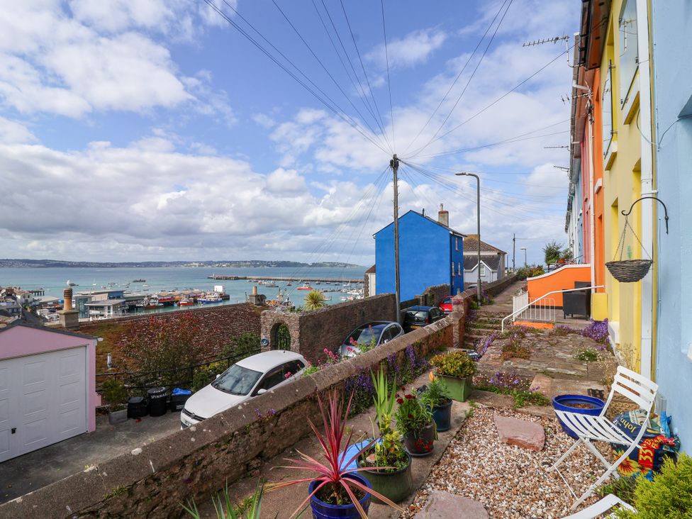 A view of houses and cars with the sea in the background at 45 North View in Brixham