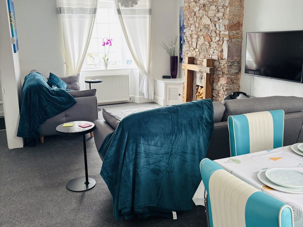 A living room with a sofa and coffee table at 45 North View in Brixham