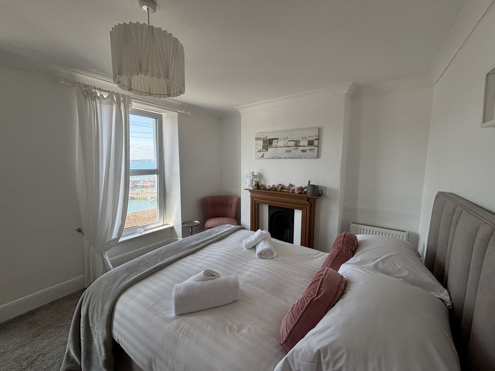 A bedroom with a bed and window view at 45 North View Brixham