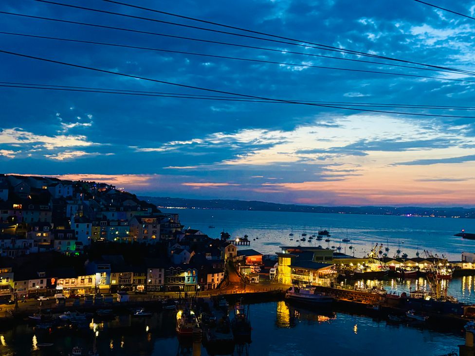 A view of the harbor with boats and houses at Lizzy’s Cottage in Brixham