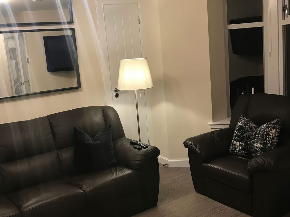 A living room with a sofa and chair at View Cottage in Inverness
