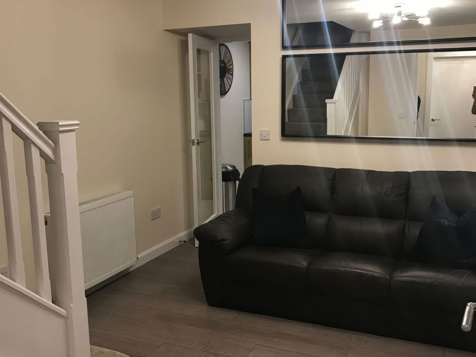 A living room featuring a sofa and a mirror at View Cottage in Inverness