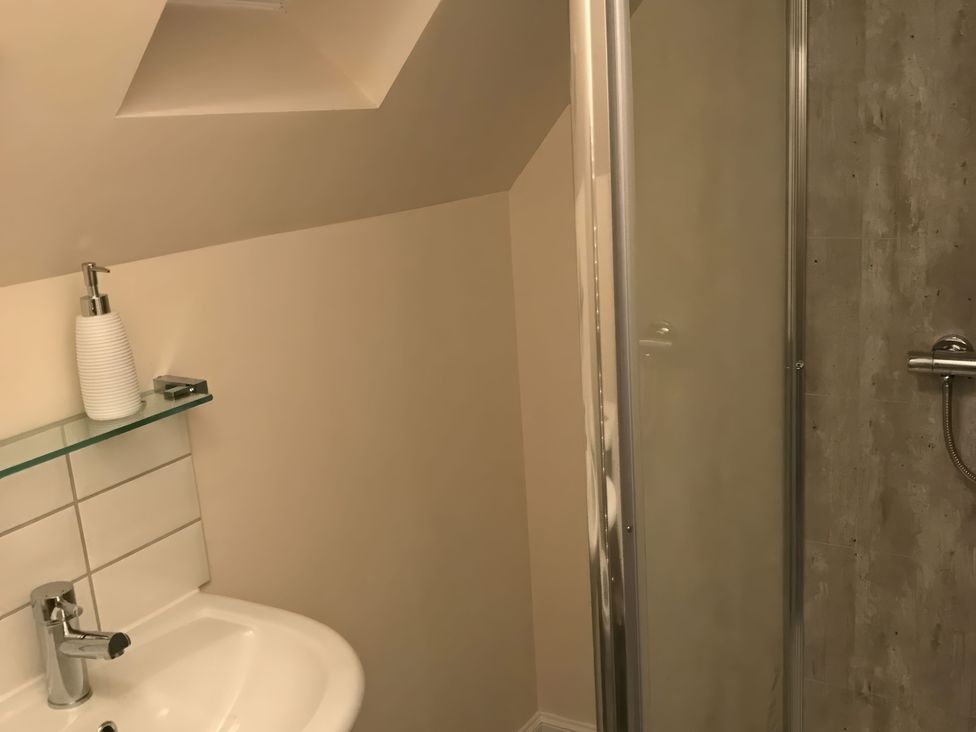A bathroom with a sink and shower at View Cottage in Inverness