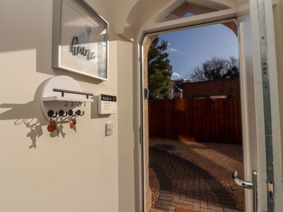 An entryway with a key holder and intercom at View Cottage in Inverness