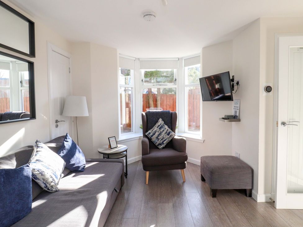 A living room with a sofa and armchair at View Cottage in Inverness