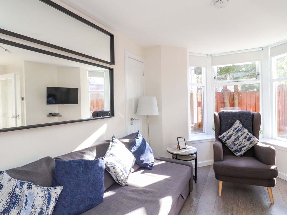 A living room with a sofa and armchair at View Cottage in Inverness