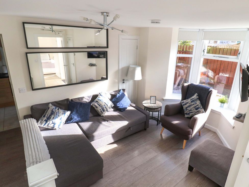A living room with a sofa and armchair at View Cottage in Inverness