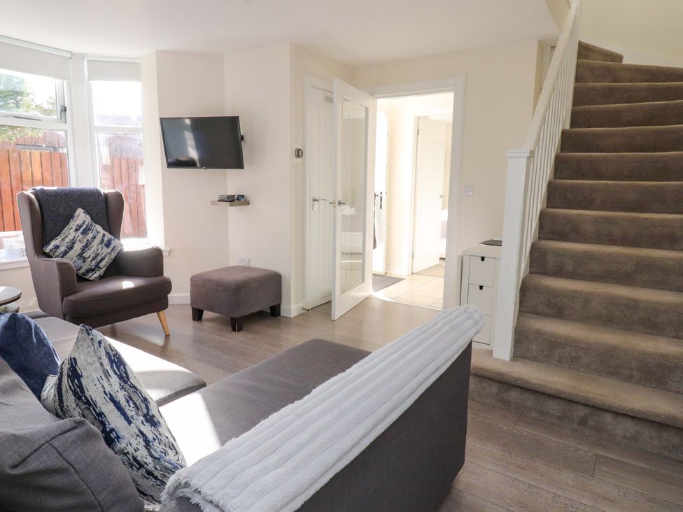 A living room with a sofa and armchair at View Cottage in Inverness