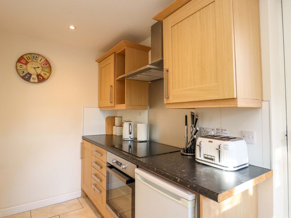 A kitchen with cabinets, countertop, kettle, and toaster at View Cottage in Inverness