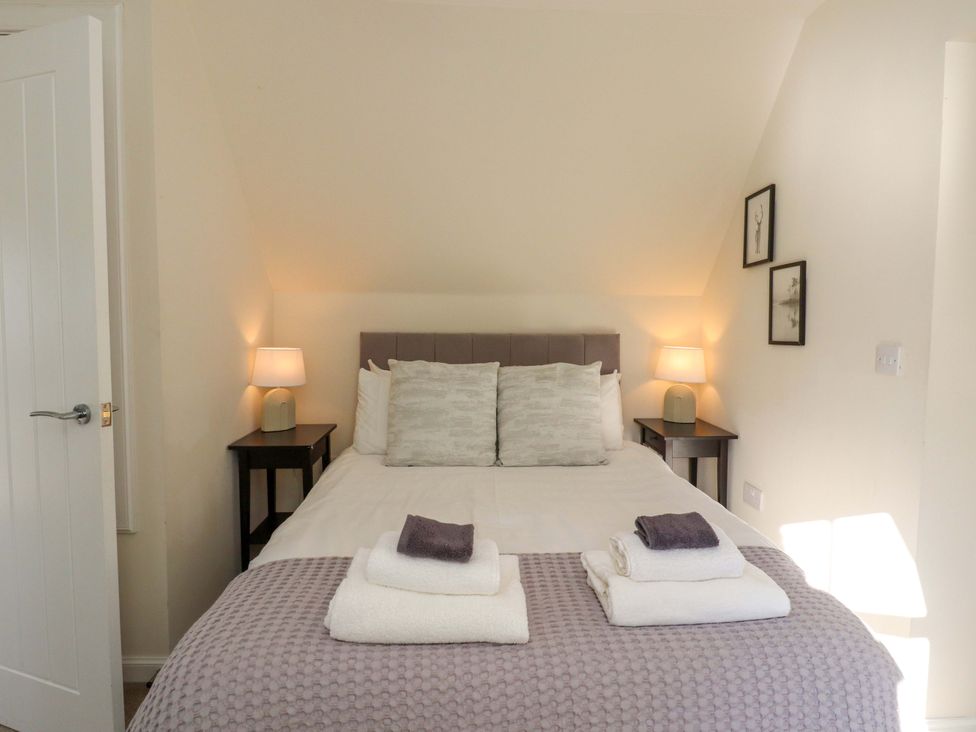 A bedroom with a bed and lamps at View Cottage in Inverness