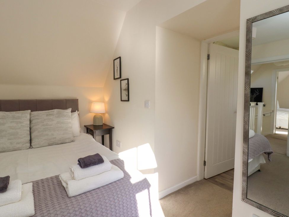 A bedroom with a bed and nightstand at View Cottage in Inverness