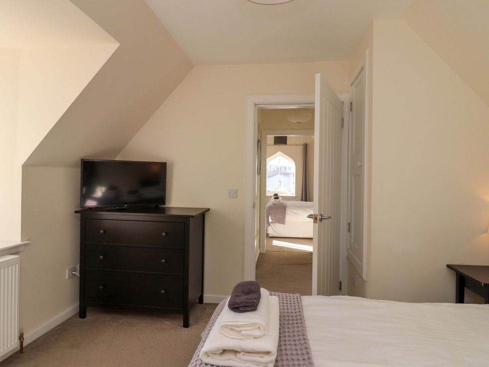 A bedroom with a dresser and a tv at View Cottage in Inverness