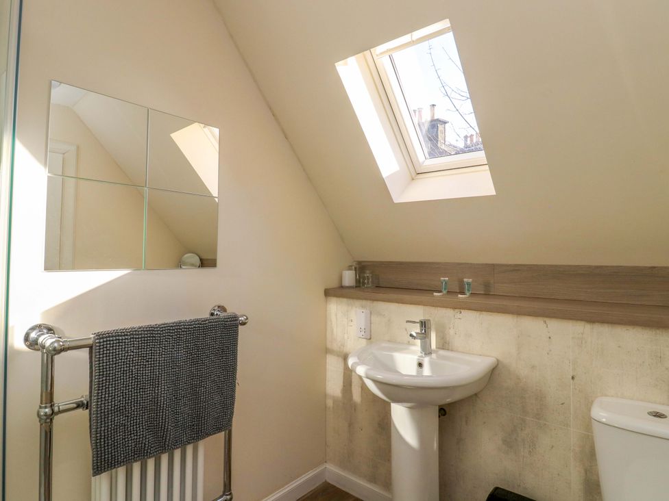 A bathroom with a sink and mirror at View Cottage in Inverness