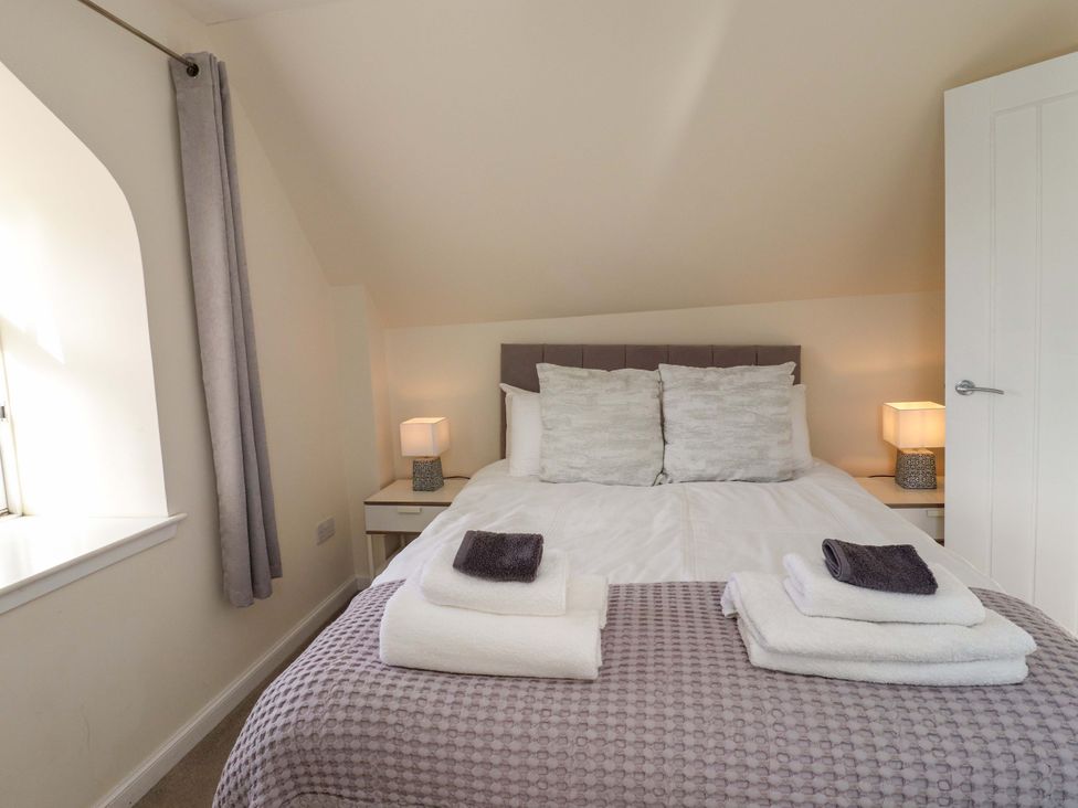 A bedroom with a bed and bedside tables at View Cottage in Inverness