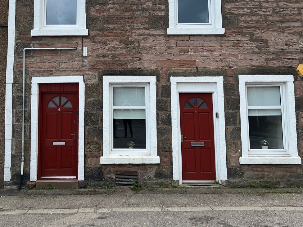 A building facade with red doors at 4 Lower Kessock Street in Inverness