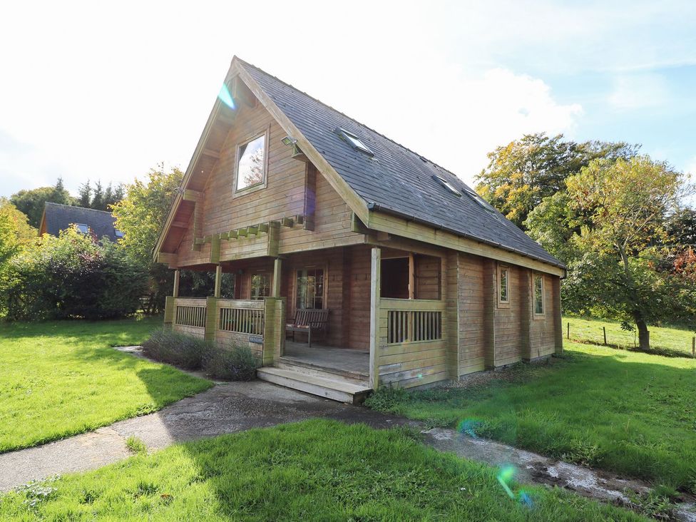 A wooden house with a porch and windows at Pen Y Clawdd near Beggar's Bush, Presteigne