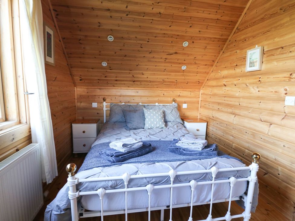 A bedroom with a bed and nightstands at Pen Y Clawdd near Beggar's Bush near Presteigne