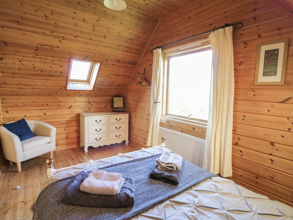 A bedroom with a bed and a chair at Pen Y Clawdd Beggar's Bush near Presteigne