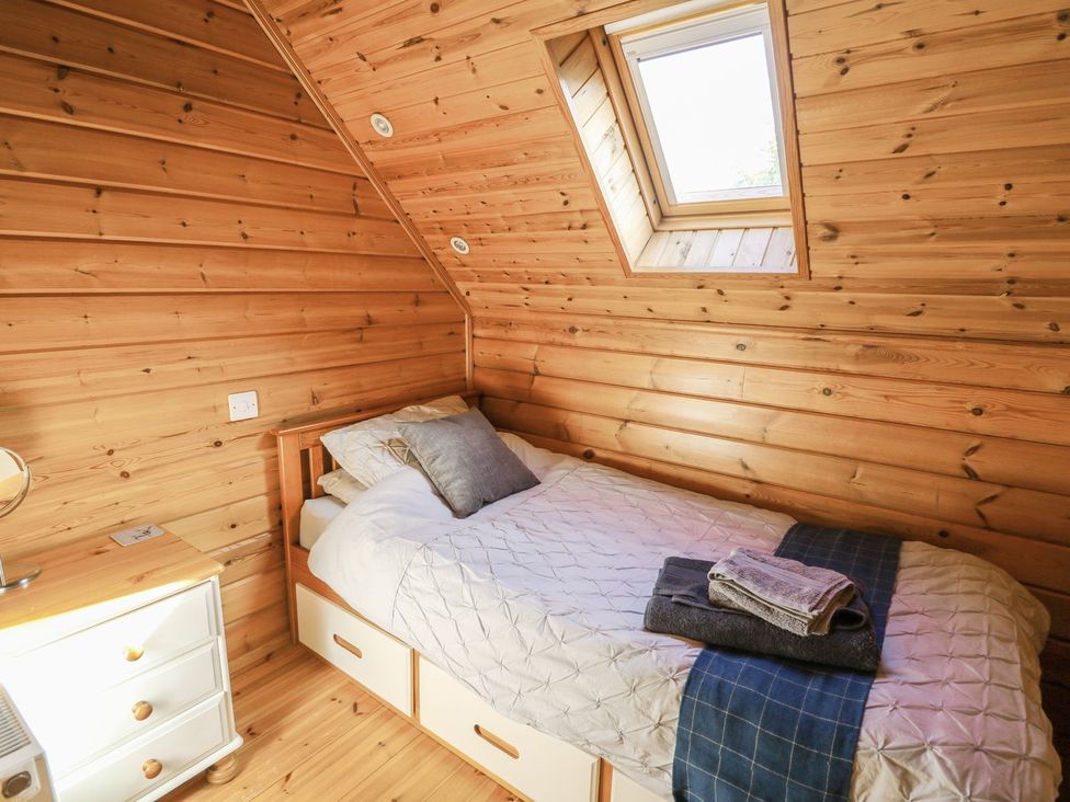 A bedroom with a bed and window at Pen Y Clawdd near Beggar's Bush near Presteigne