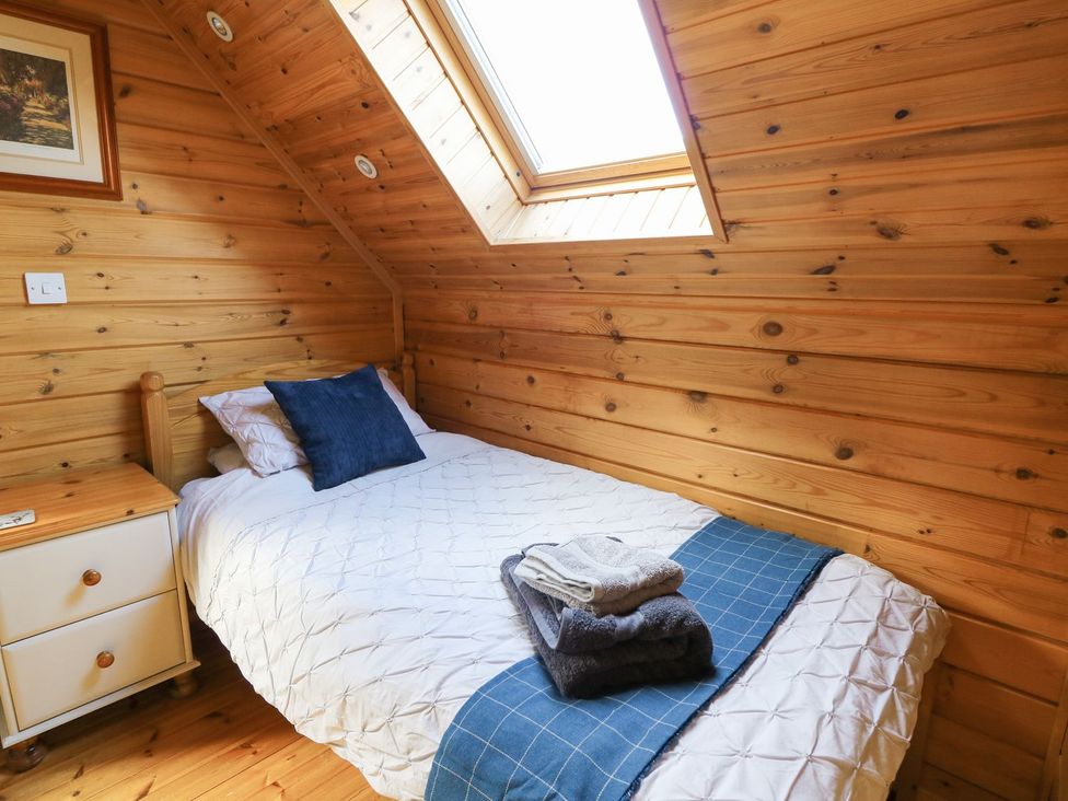 A bedroom with a bed and nightstand at Pen Y Clawdd Beggar's Bush near Presteigne