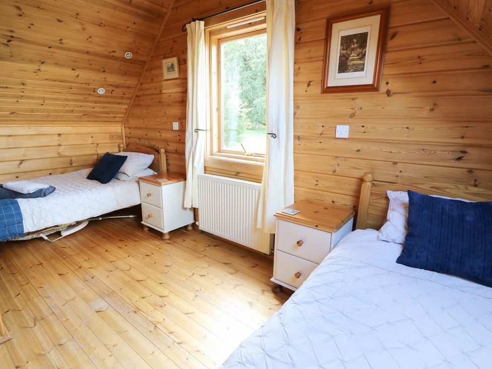 A bedroom with two beds and a window at Pen Y Clawdd near Presteigne