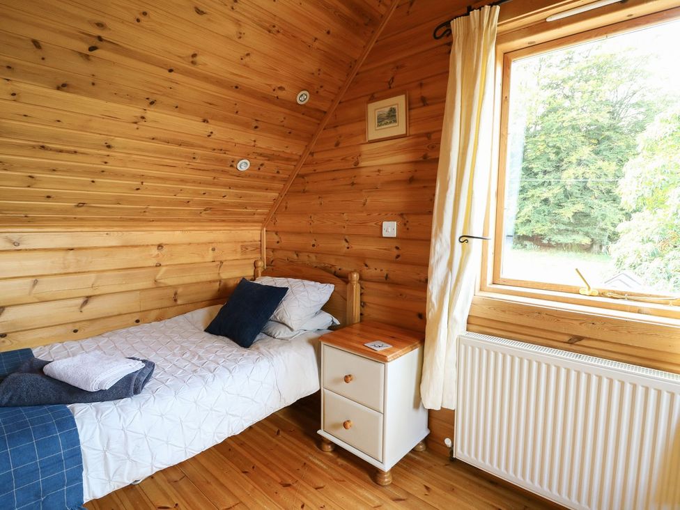 A bedroom with a bed and window at Pen Y Clawdd near Beggar's Bush near Presteigne