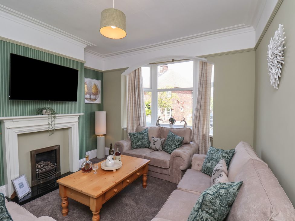 A living room with a sofa and coffee table at Crescent Bay House