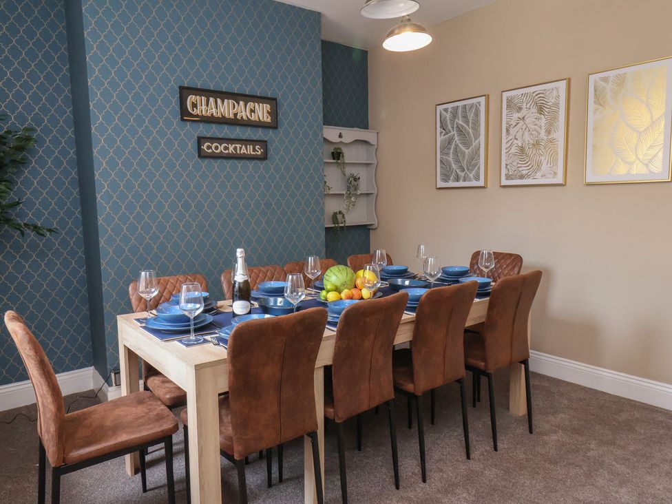 A dining room with a table set for dinner at Crescent Bay House