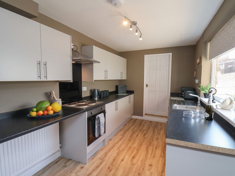 A kitchen with fruit on a counter at Crescent Bay House