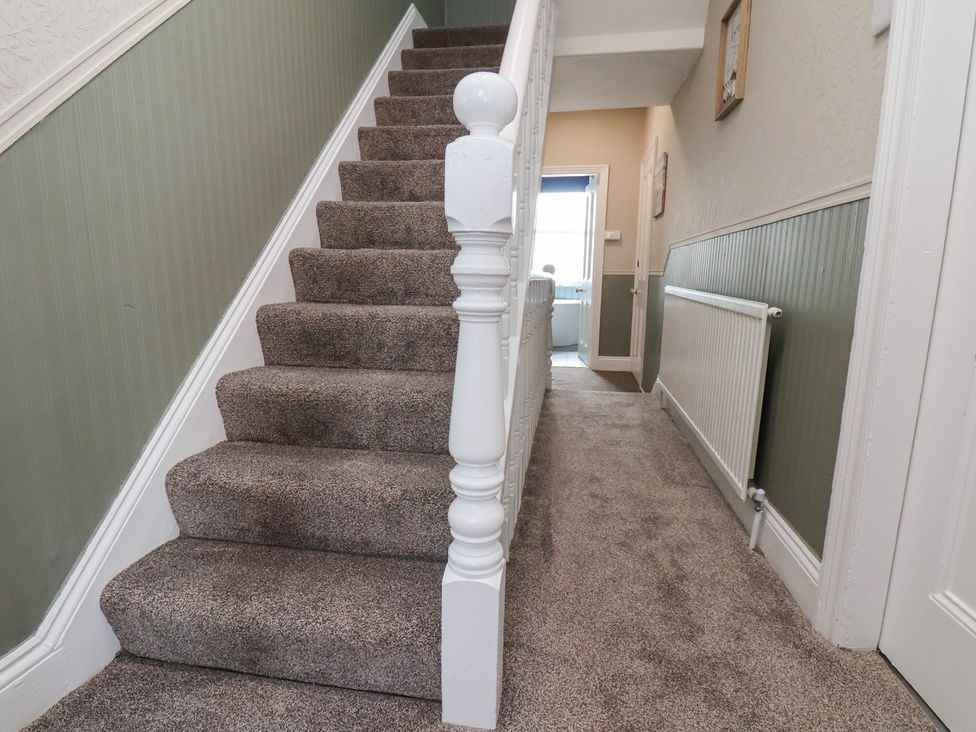 A staircase and hallway at Crescent Bay House