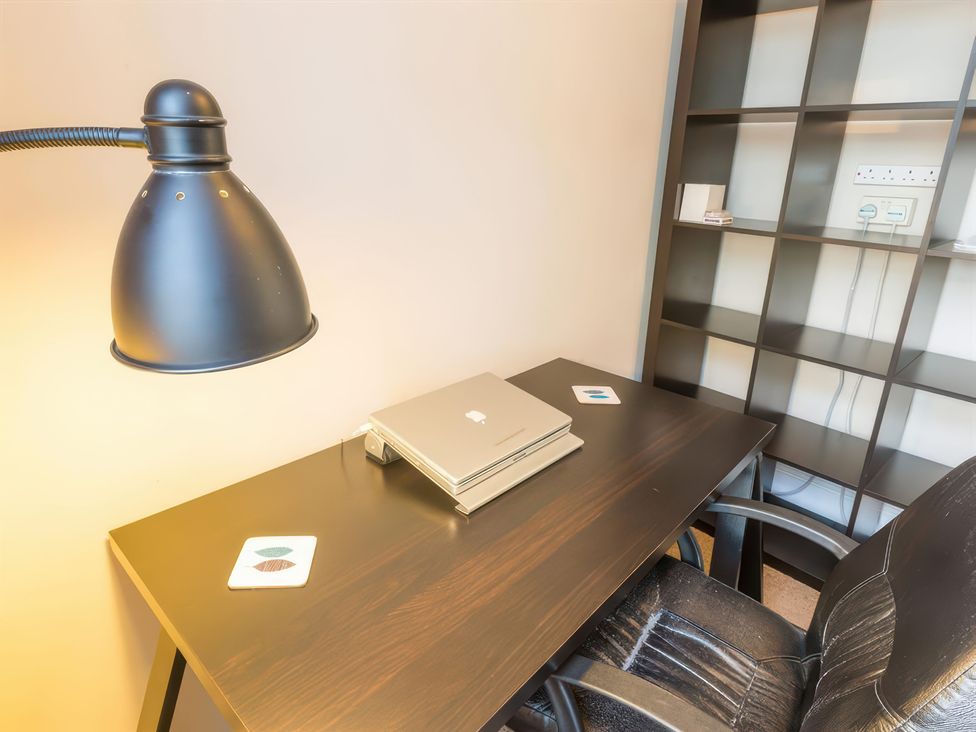 An office with a desk and lamp at River Cottage Inverness