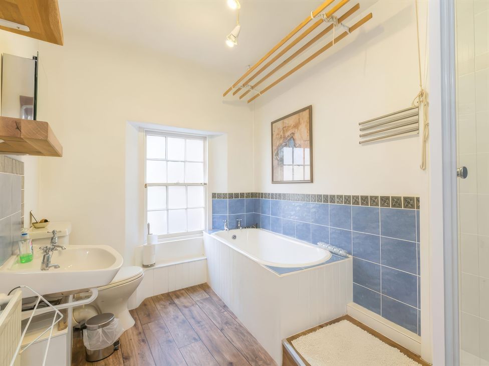 A bathroom with sink and bathtub at River Cottage in Inverness