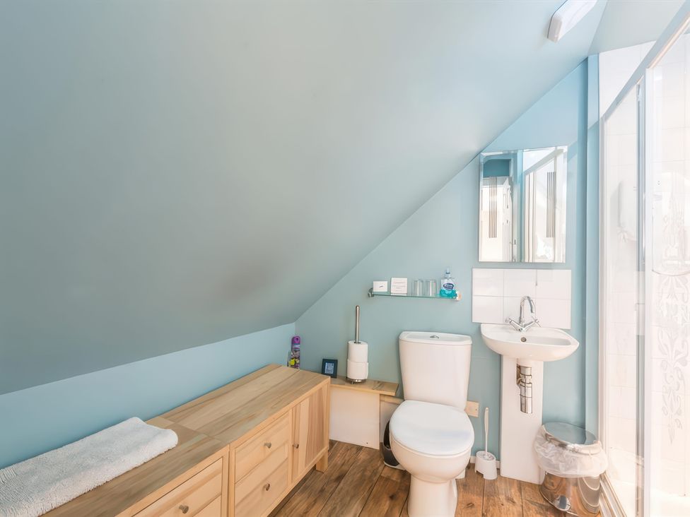 A bathroom with a toilet and a sink at River Cottage in Inverness