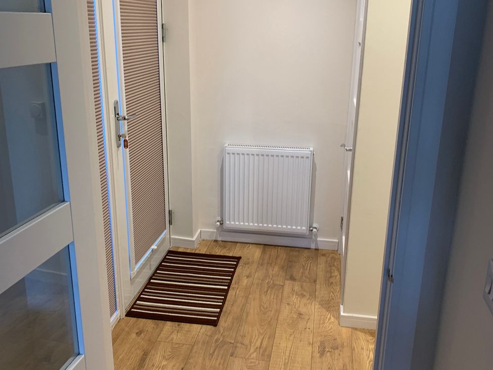 An entrance hall with a door and radiator at View Apartment in Inverness