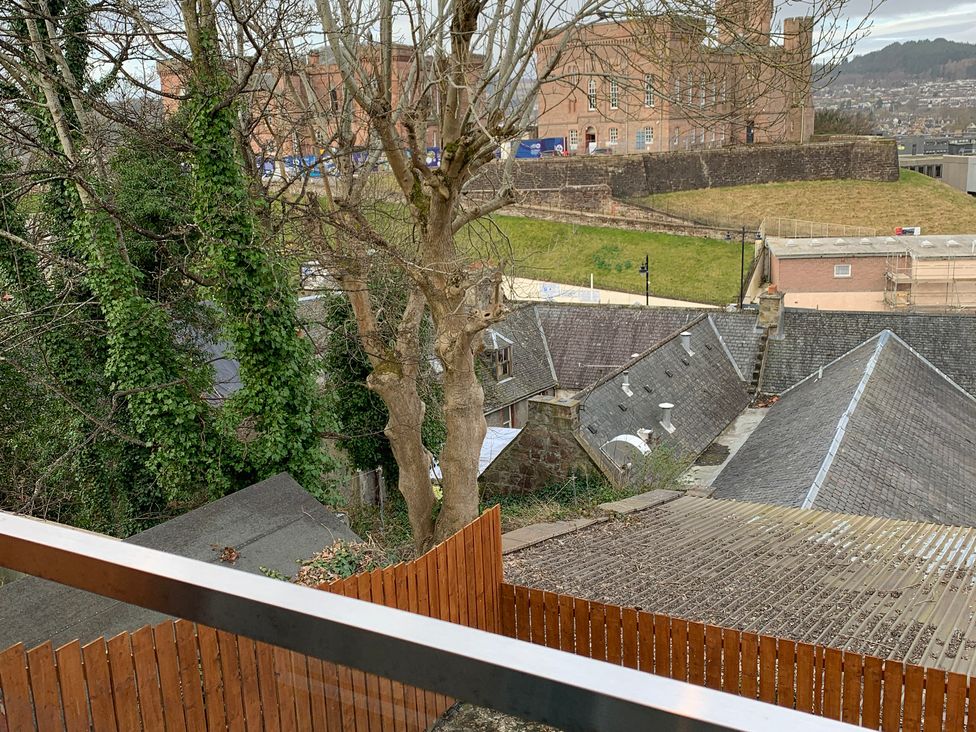 An outdoor view showing rooftops and trees at View Apartment in Inverness