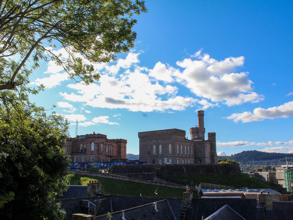 A view of historic buildings and trees at View Apartment in Inverness
