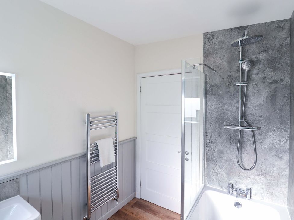 A bathroom featuring a shower and bathtub at View Apartment in Inverness