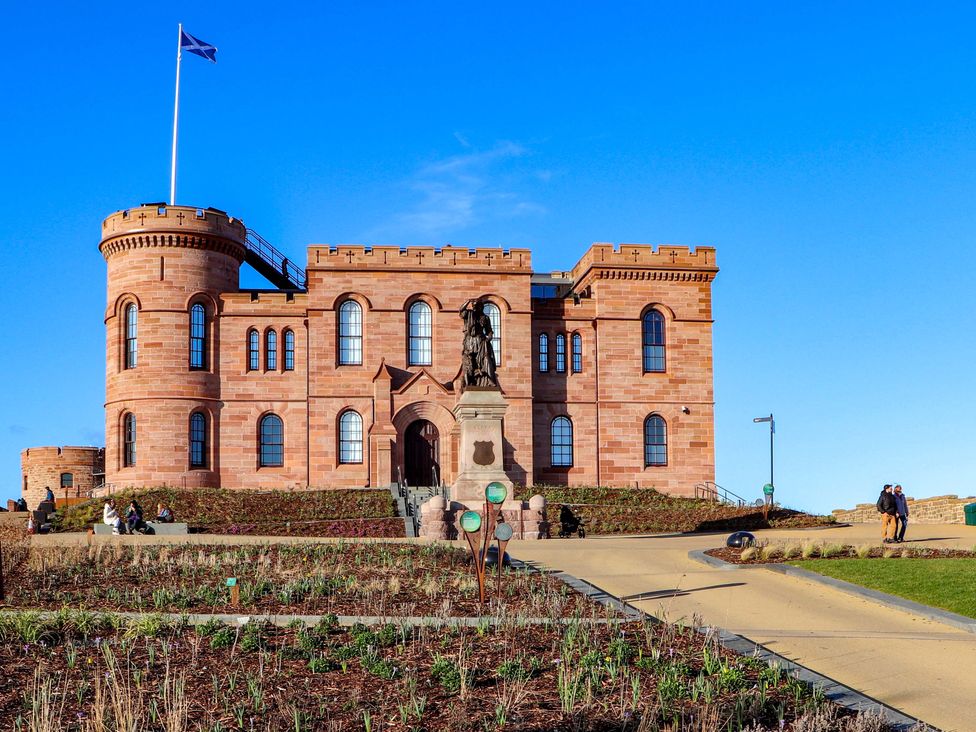 A castle with a statue in front at View Apartment in Inverness