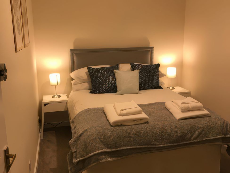 A bedroom with a bed and side tables at 2 Lower Kessock Street inverness